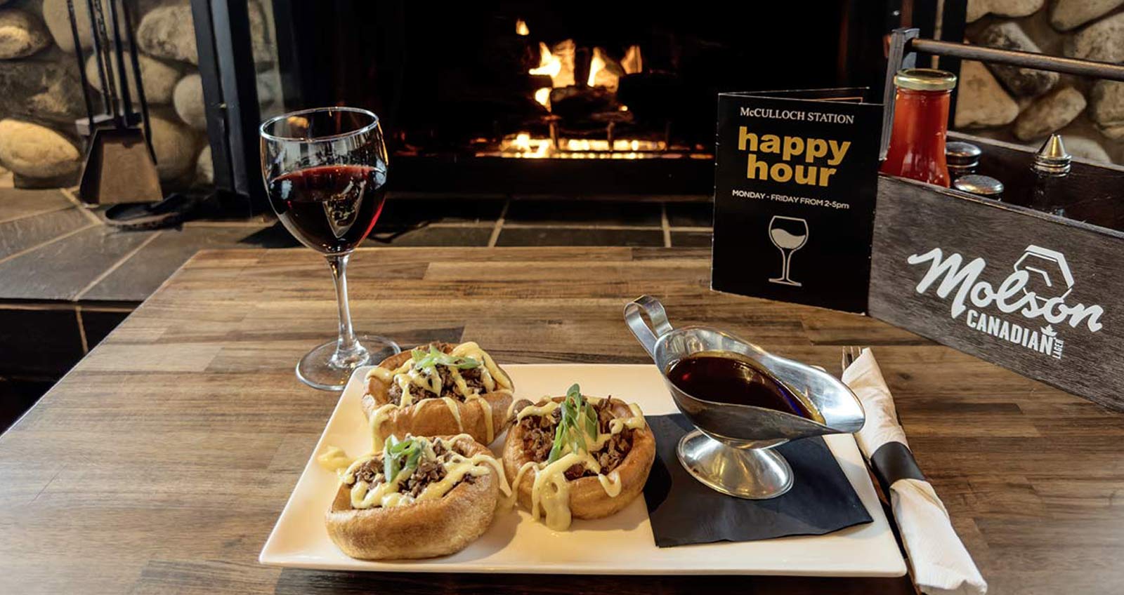 A view of the fireplace at McCulloch Station Pub with guests enjoying the cozt atmosphere